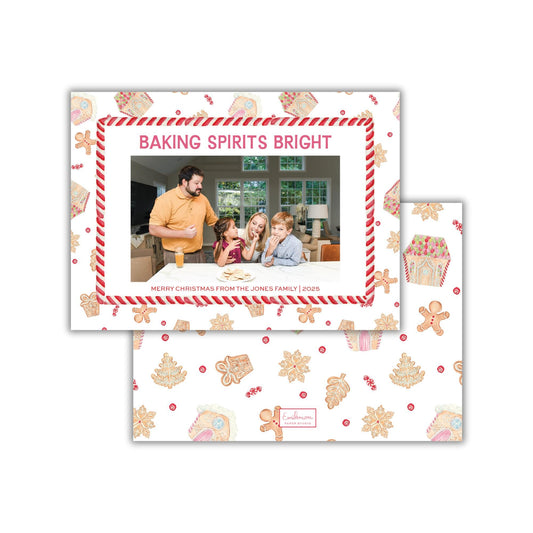 A family photo is displayed on a card with a festive pattern of gingerbread houses and other holiday-themed elements.
