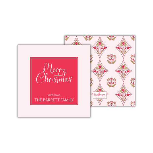 two square cards with Christmas-themed designs. The card on the left has a red background with the text &quot;Merry Christmas with love, THE BARRETT FAMILY&quot; written in white cursive font. The card on the right has a pink background with a repeating pattern of red and white flowers.